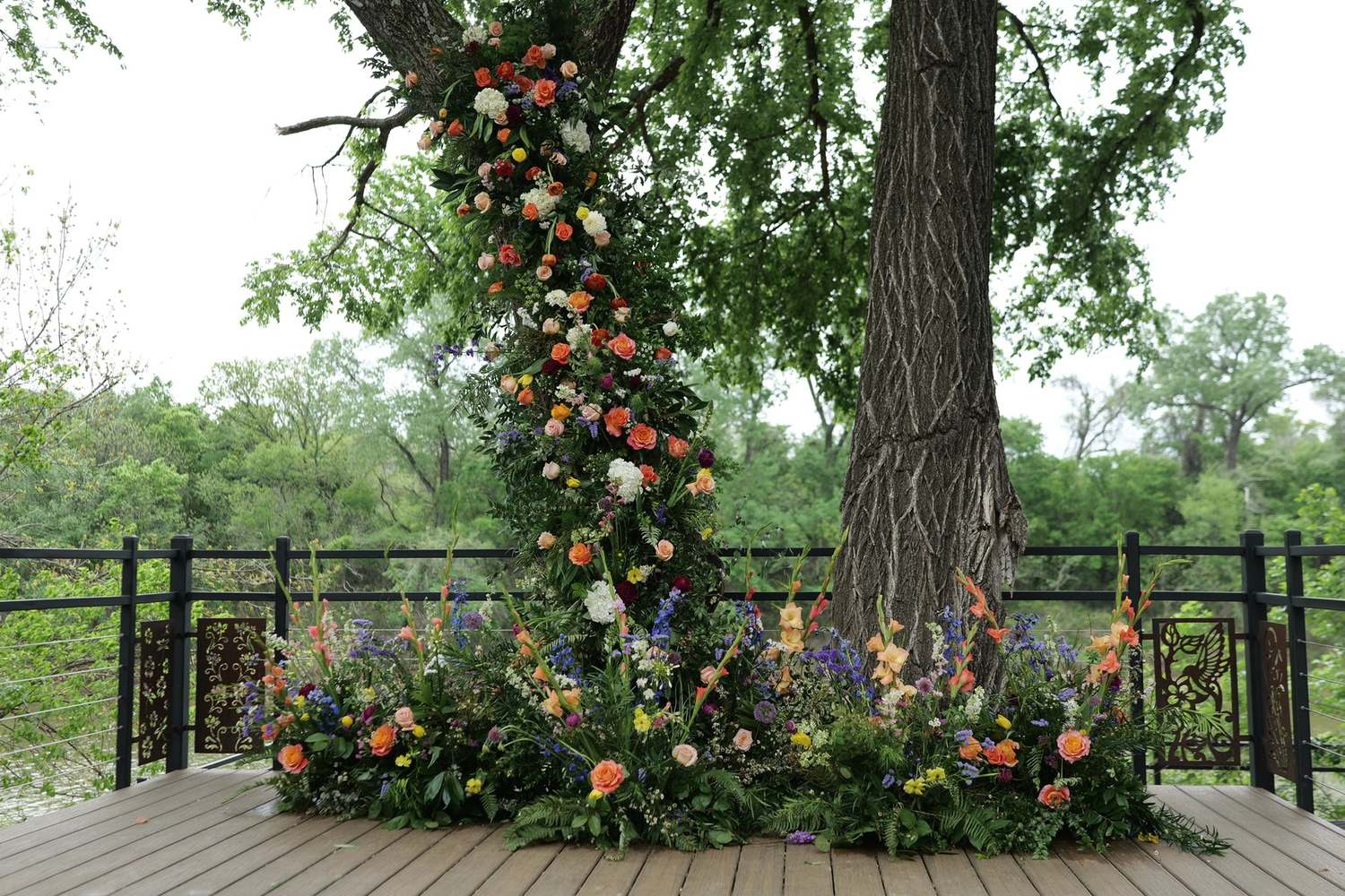 Large tree collared in florals on a decked terrace